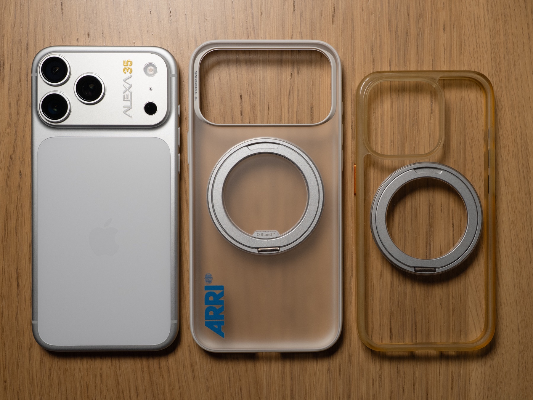 Two clear cases with different amounts of yellowing, beside a phone for color reference